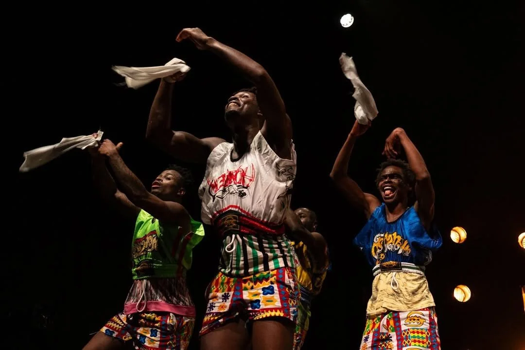 Afrikan Party performers dancing with white cloths.